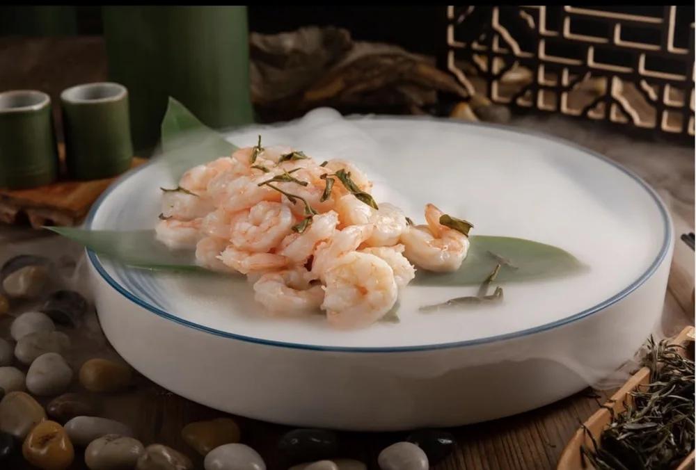 Hand-peeled shrimp sauteed with Dragon Well tea leaves on a celadon-rimmed plate